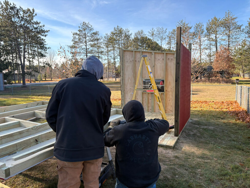 Members of Domtar’s Nekoosa Mill assemble the frame of a new outdoor playhouse for students at Chahk Ha Chee Head Start.