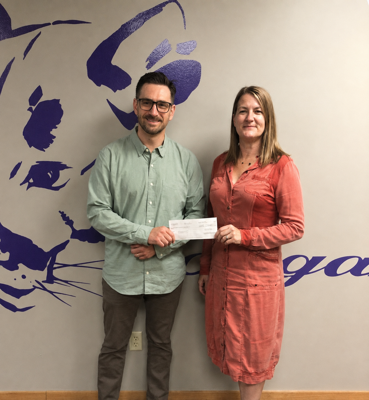 Tracy Roach of Domtar’s Rothschild Mill presents a $2K Your Way check to Ice Age Trail Alliance Director of Philanthropy Bix Firer.